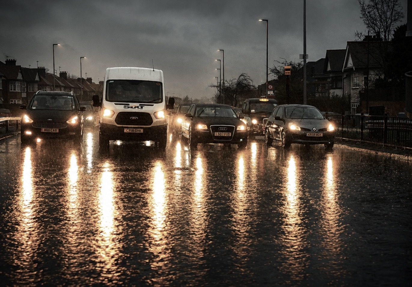 Traffic lights reflected on a rain-covered road